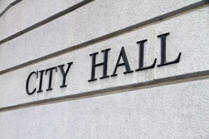 The words “City Hall” on the side of a building.
